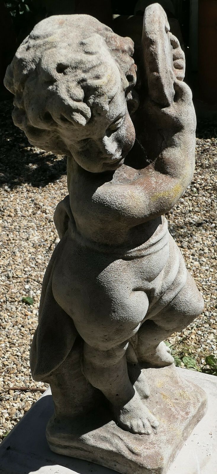 Old Weathered Statue Of A Putti Playing Tambourine photo buy