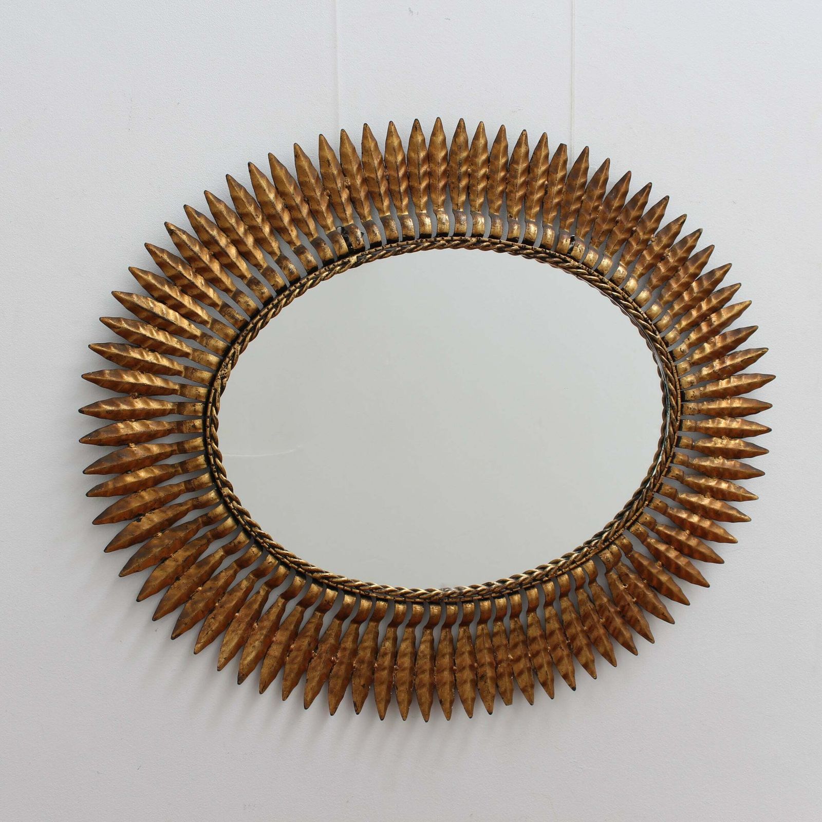 Mid Century Spanish Gilt Metal Sunburst Mirror With Leaf Motif, Circa 1960s.