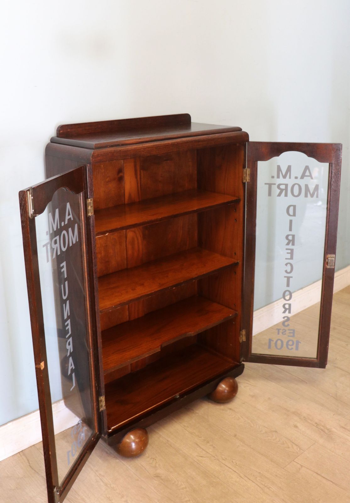 A Lovely Art Deco Styled Cabinet Sign Written With The Details Of A Funeral Directors. photo Furniture