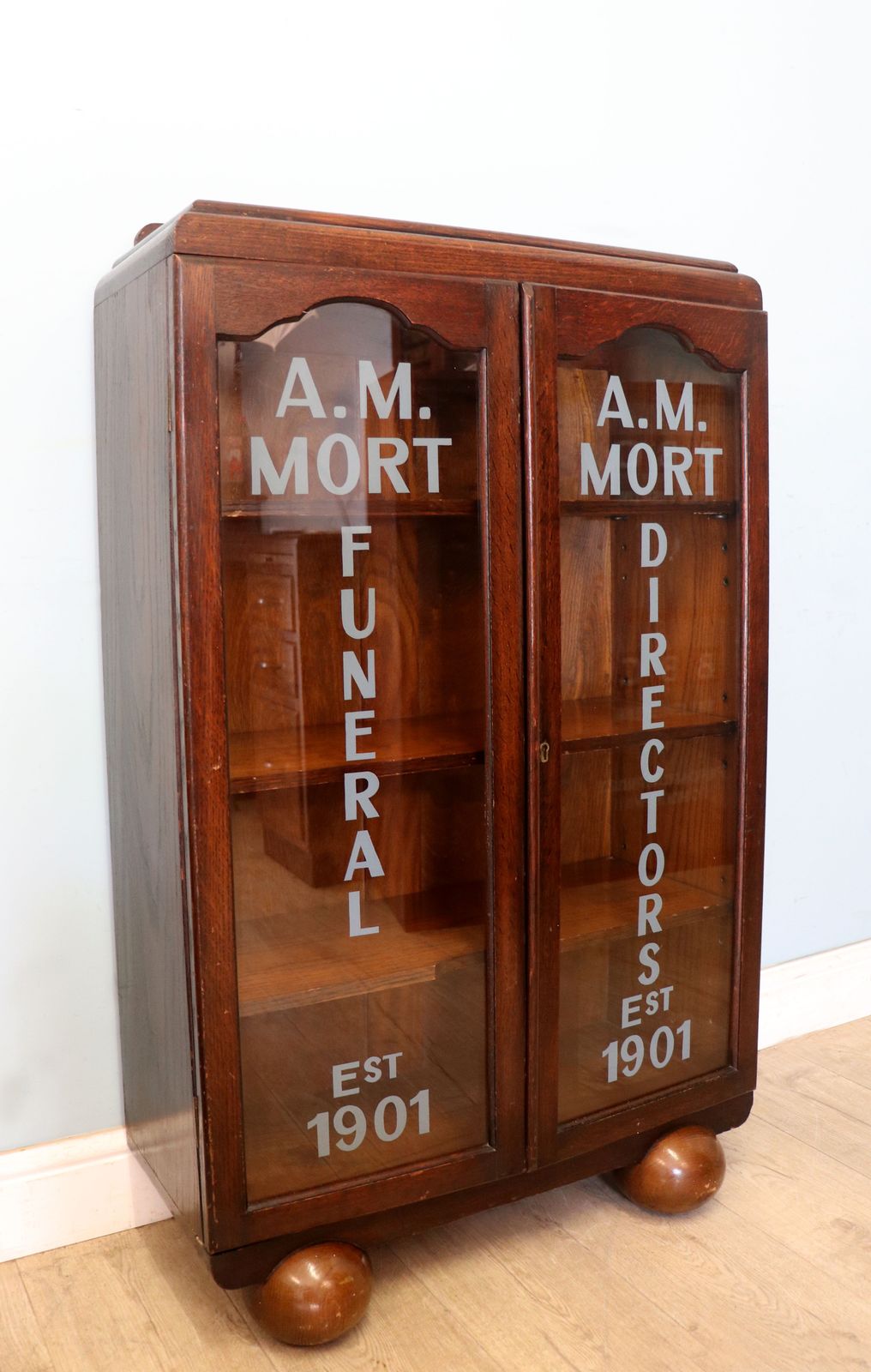 A Lovely Art Deco Styled Cabinet Sign Written With The Details Of A Funeral Directors. photo 595.0