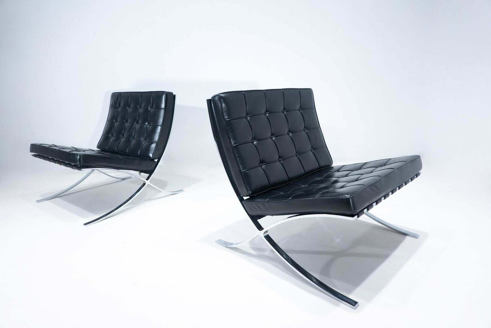photo for sale Pair Of Black Leather Barcelona Chairs By Mies Van Der Rohe For Knoll, 1960s