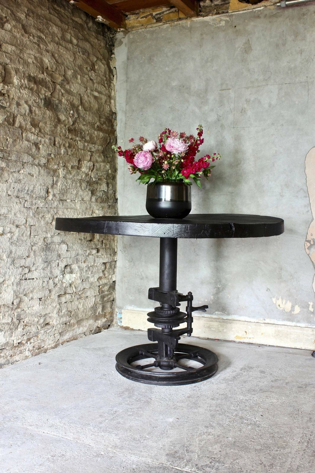 Shift Reclaimed Chunky Scorched Timber Circular Table With A Heavy Pedestal Base Made Out Of An Old Gear System photo Furniture