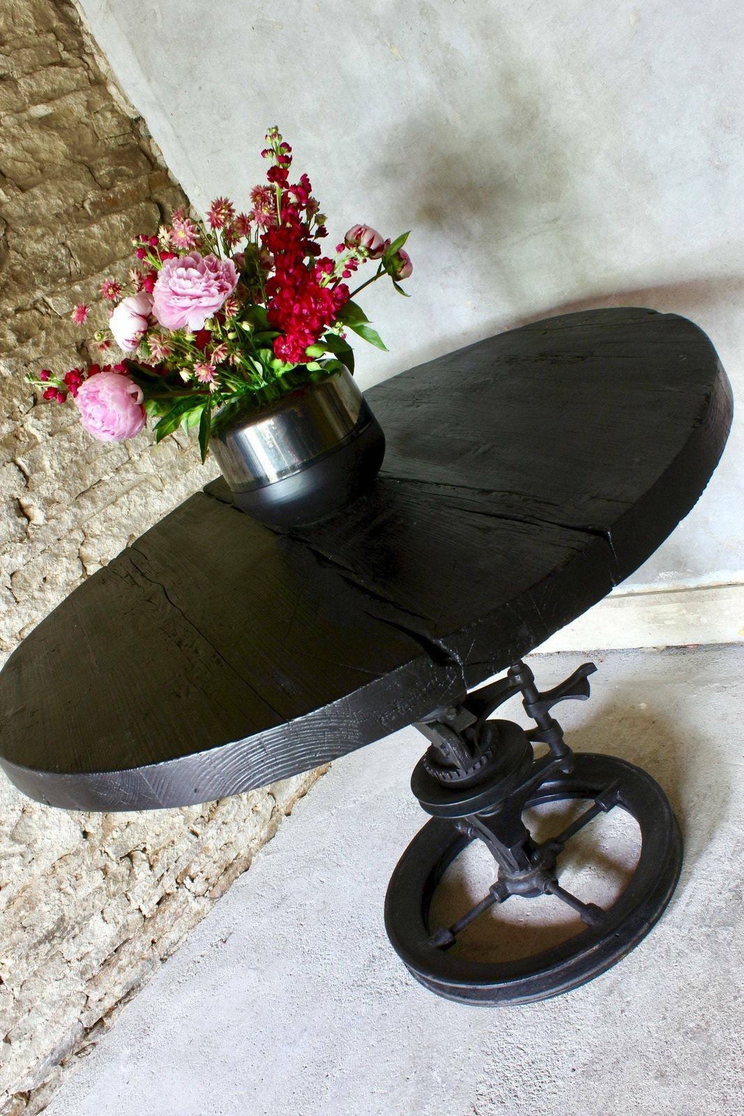 Shift Reclaimed Chunky Scorched Timber Circular Table With A Heavy Pedestal Base Made Out Of An Old Gear System photo 1795.0