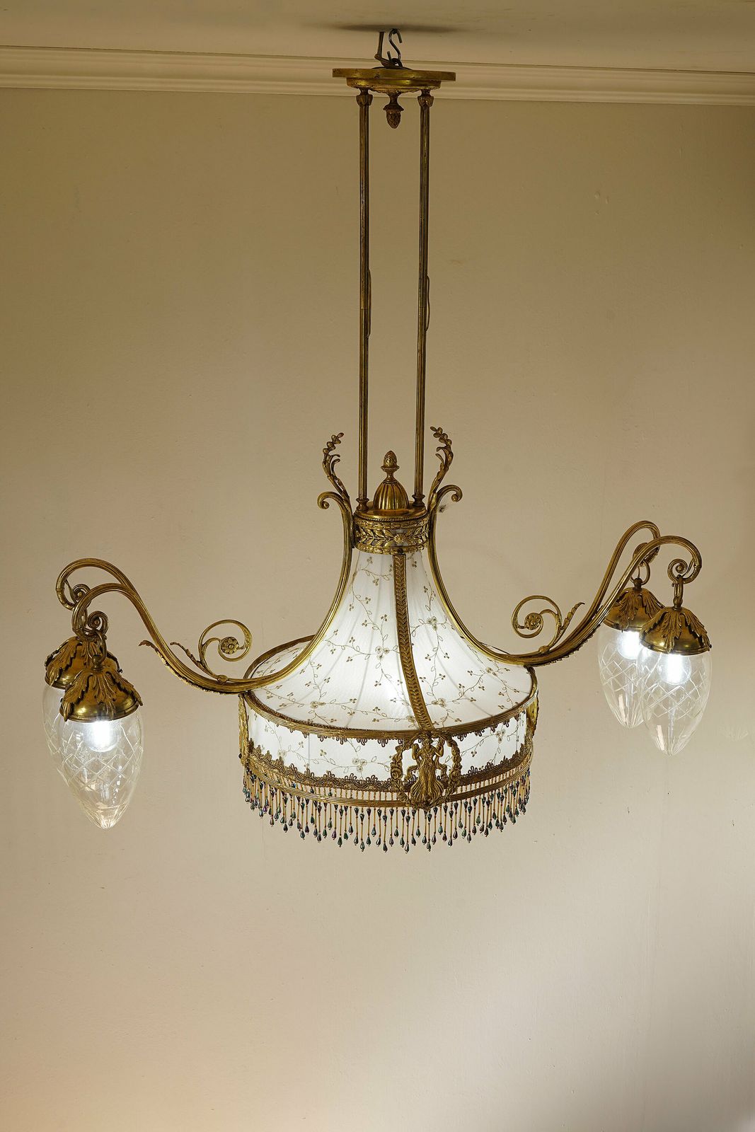 photo for sale Art Nouveau Brass Chandelier, With A White And Gold Tulle Fabric Lampshade