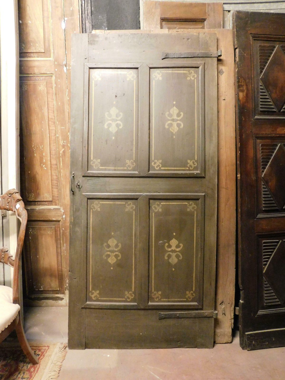 Old Door With 4 Painted Panels, Yellow Decorations On Green Background, Italy photo for sale