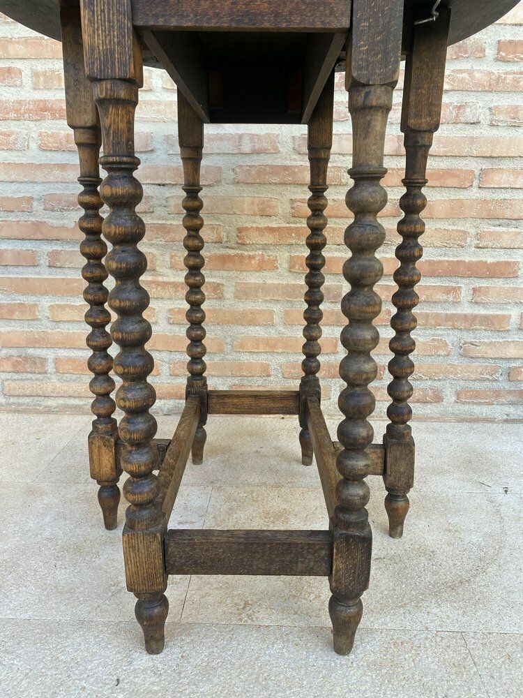 photo for sale Round Folding Center Oak Table With Carved Top And Solomonic Legs, 1940s