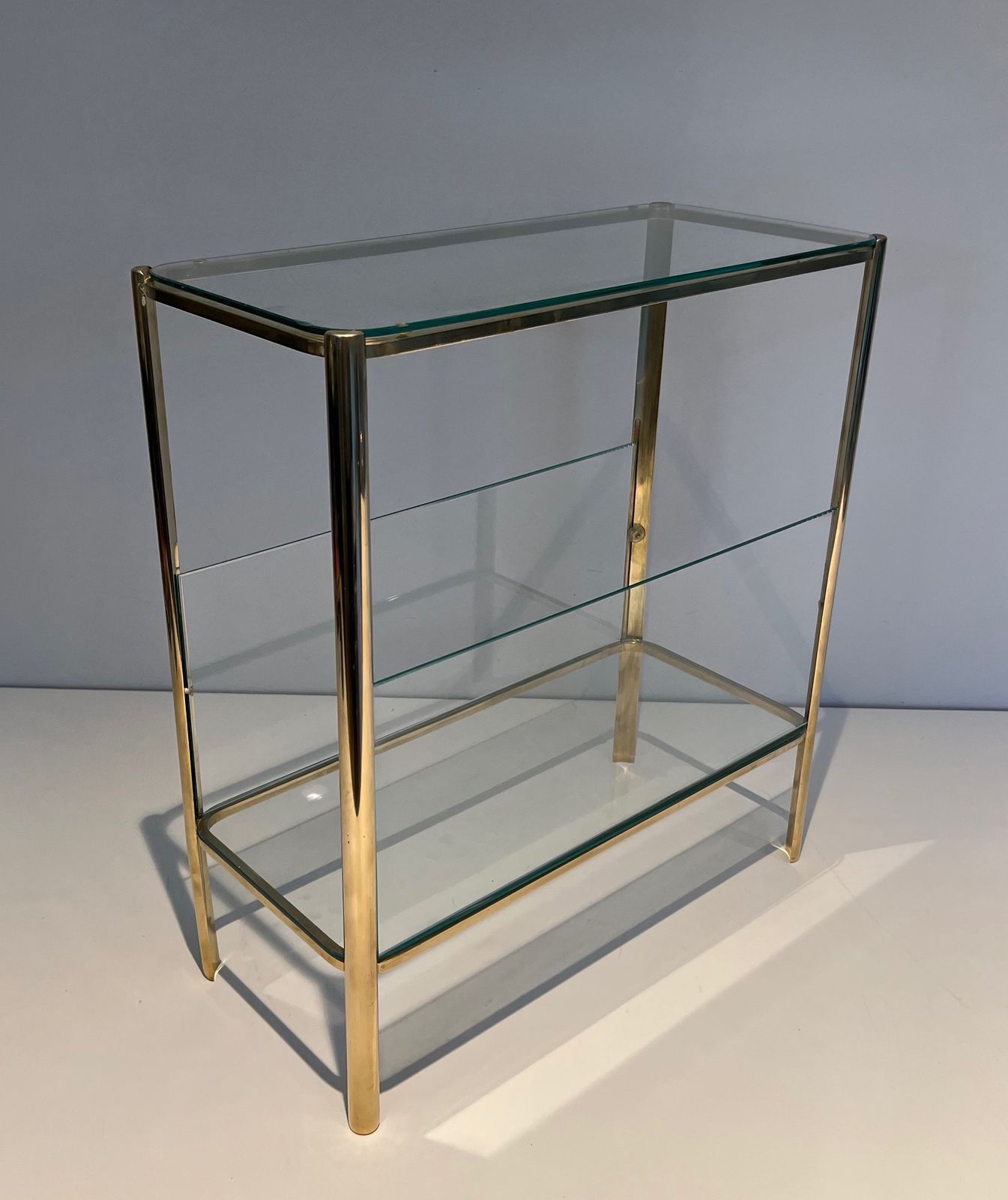 Magazine Rack In Polished Bronze And Glass Signed Jacques Théophile Lepelletier And Stamped Broncz photo furniture
