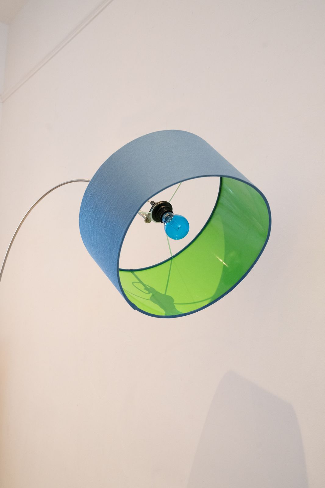 Standard Lamp With Blue Shade With Green Interior Over Arched Shaft To A U Shape photo 400.0