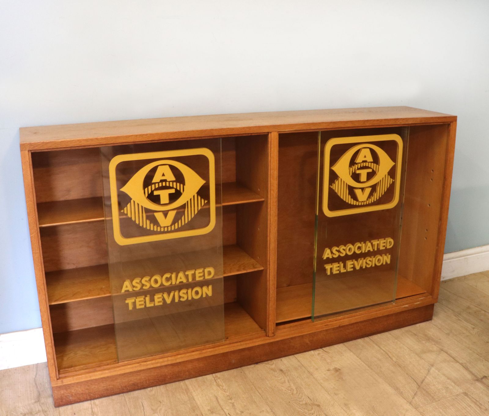 A Mid Century Oak Bookcase Cabinet, Later Sign Written For Associated Television. photo for sale