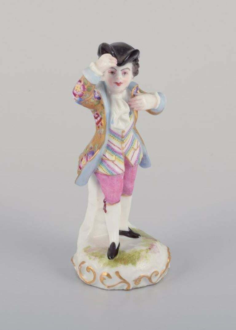 Meissen, Germany. Porcelain Figurine Of Young Man In Elegant Attire. photo furniture