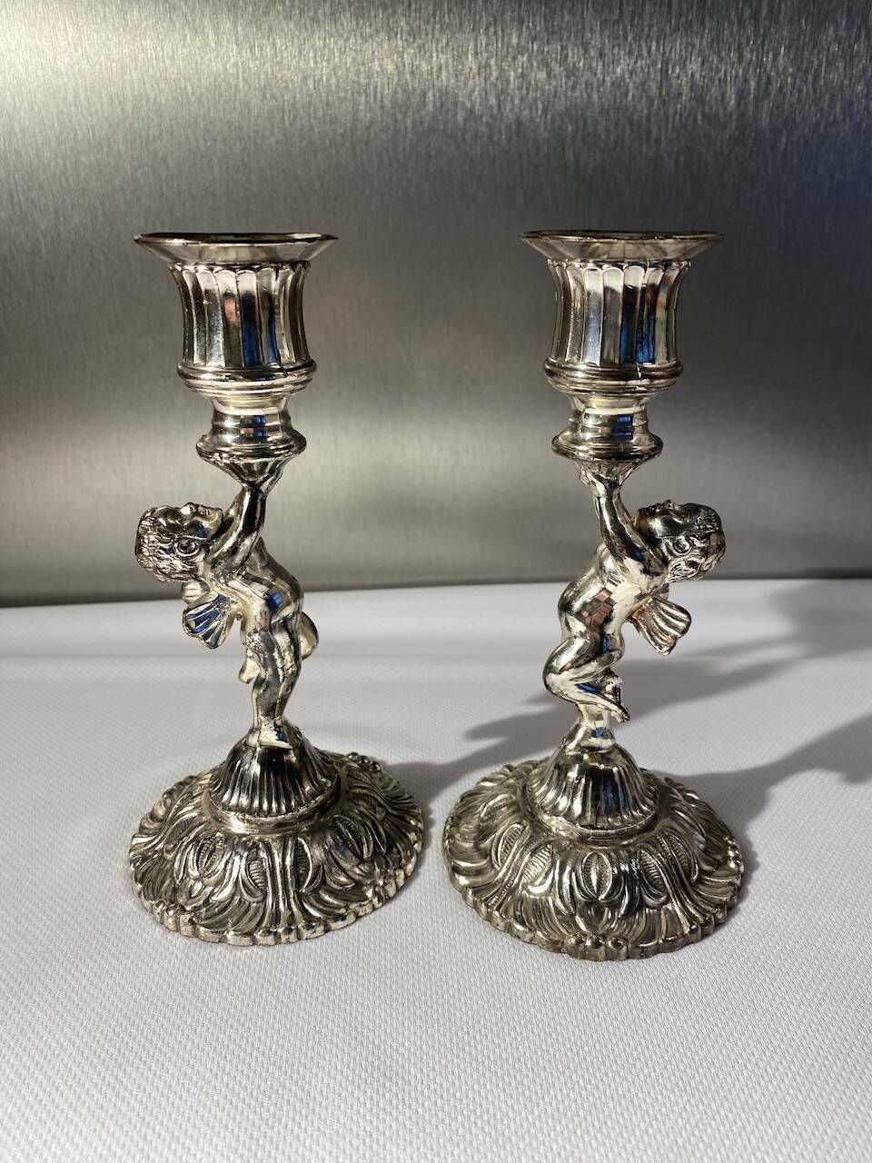 Two Silver Metal Candlesticks Decorated With 20th Century Cherubs photo for sale