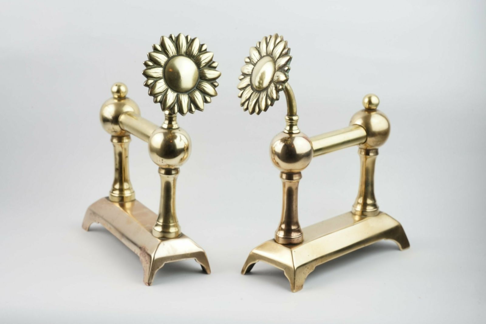 A Pair Of Aesthetic Movement Sunflower Brass Fire Dogs, Circa 1875