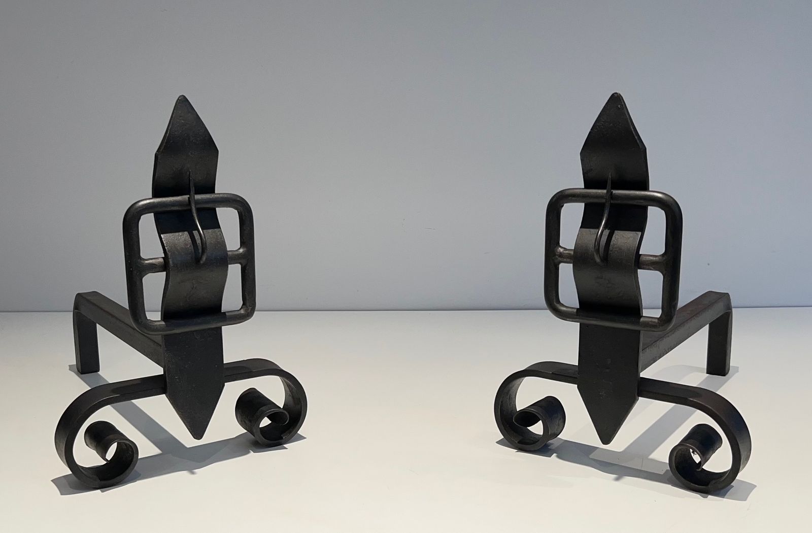 Pair Of Modernist Andirons Representing A Belt