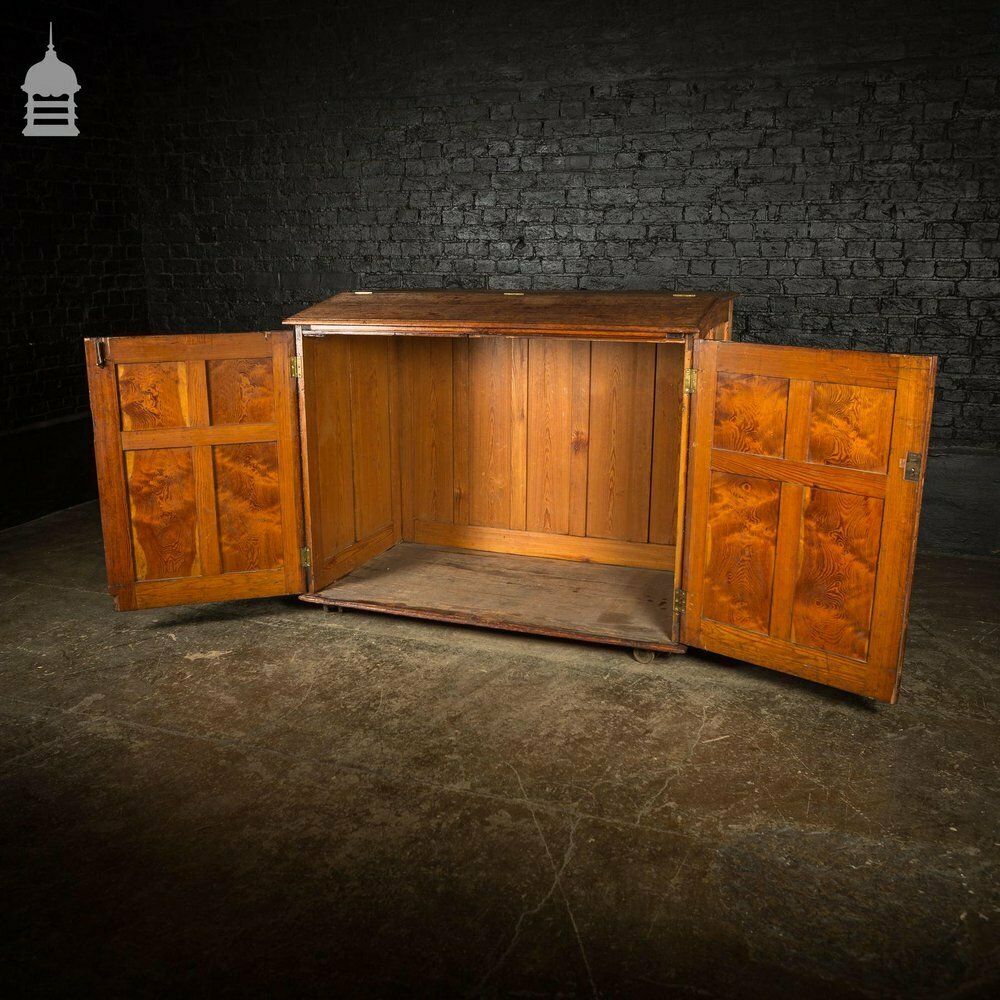 1140.0 Large 19th C Figured Pitch Pine Ecclesiastical Cupboard With Double Doors, Opening Top And Metal Castors photo