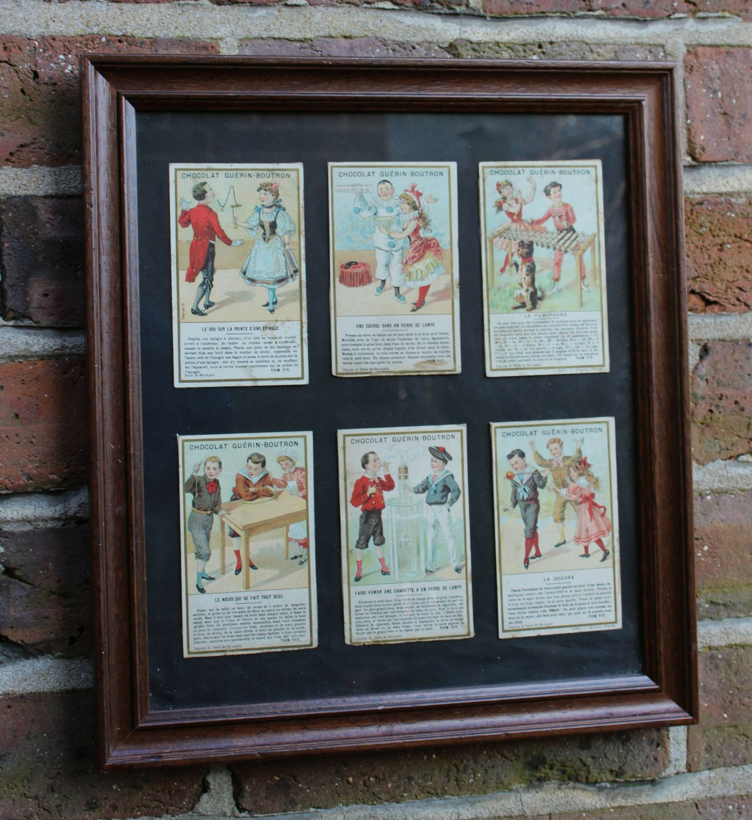 A Framed Set Of 6 Chocolat Guérin Boutron Trade Cards From The Tom Tit Series photo furniture