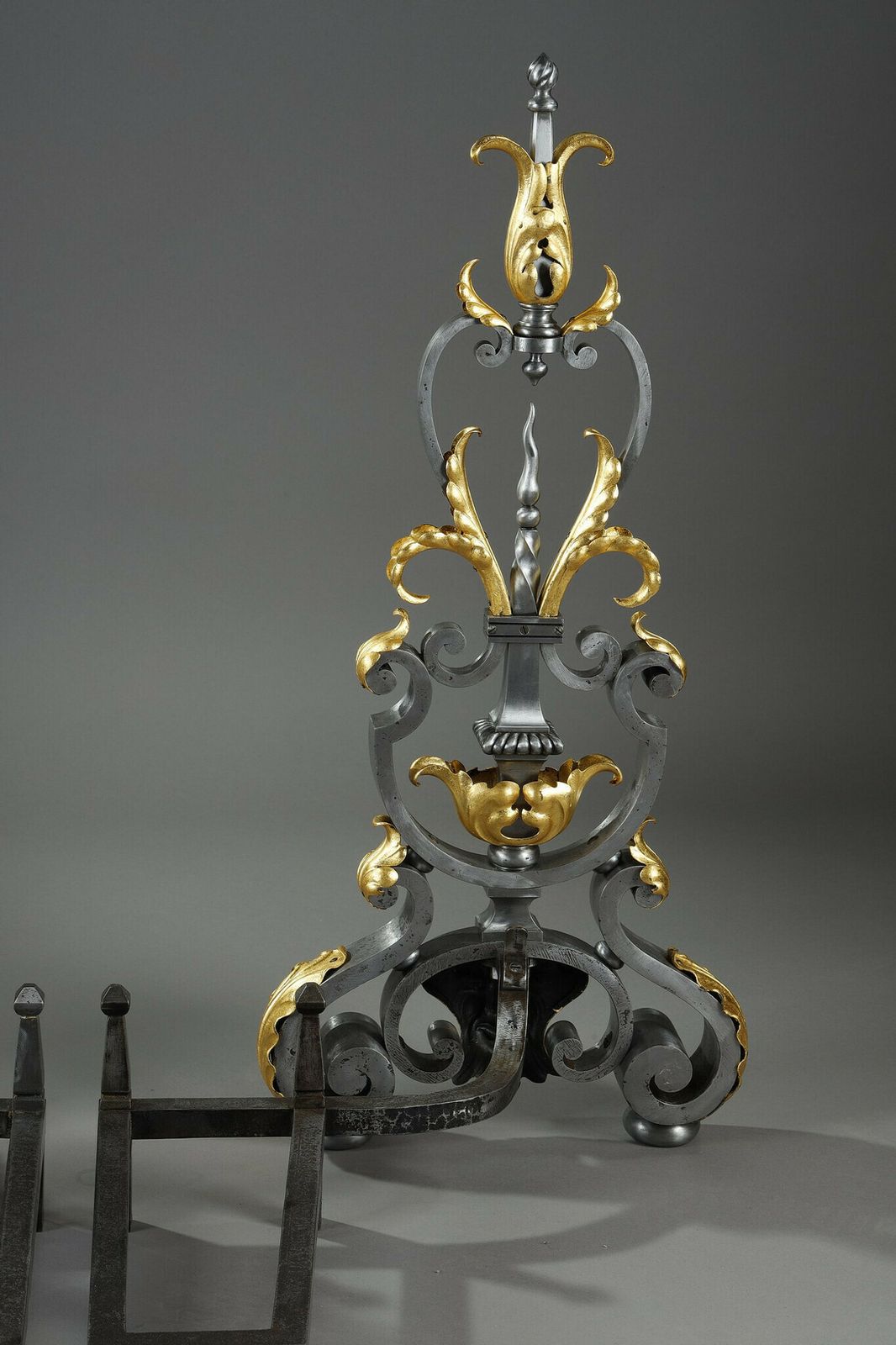 photo for sale Pair Of Wrought Iron Landiers With Foliage, Mask And Scroll Decoration