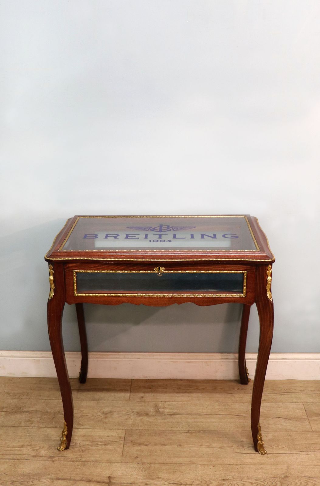 A Lovely 20th Century French Hardwood Bijouterie Display Table Later Sign Written For Breitling Watches. photo furniture