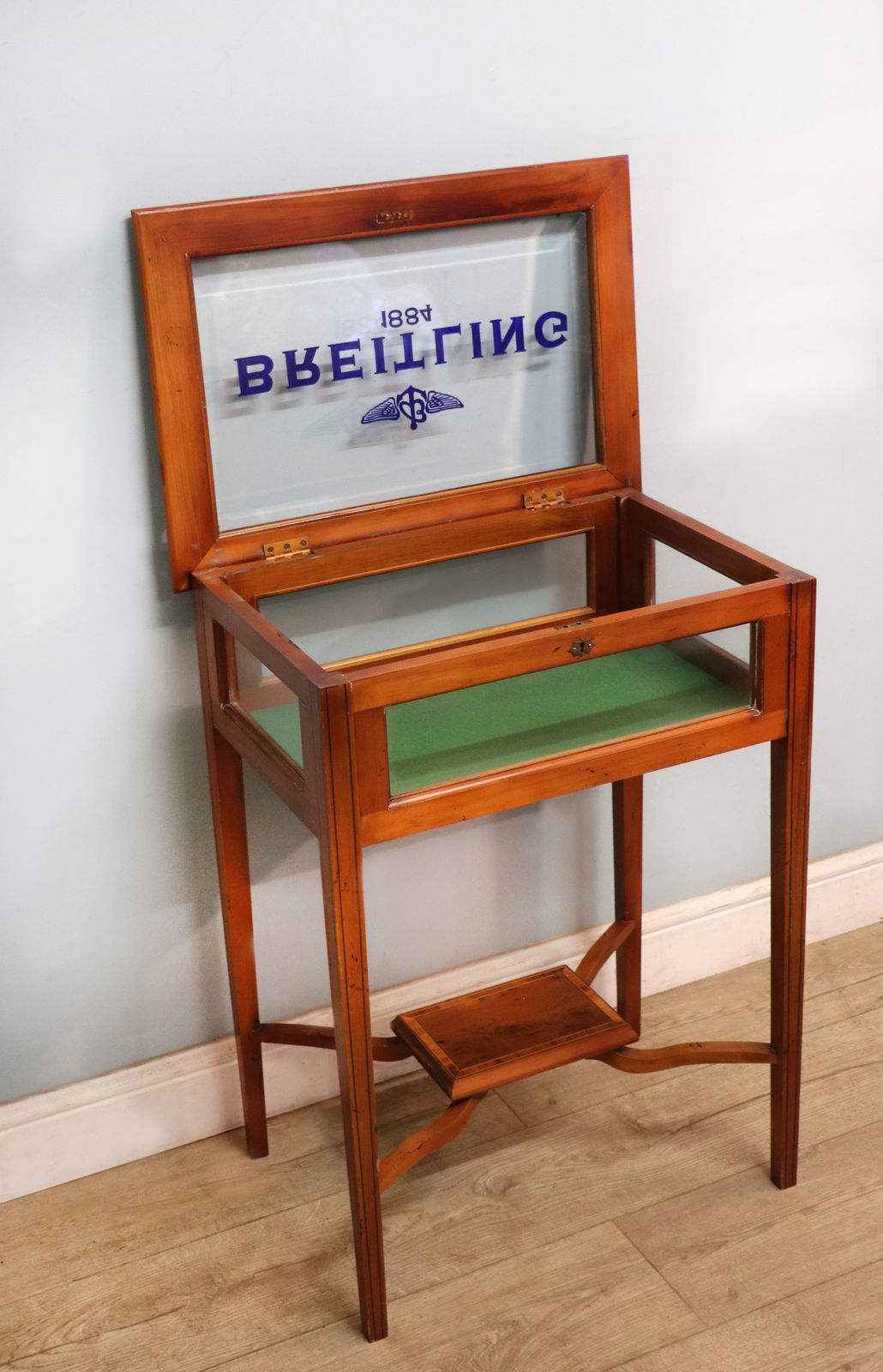 photo furniture A Lovely Yew Wood Veneered Bijouterie Display Table, Later Sign Written For Breitling Watches.