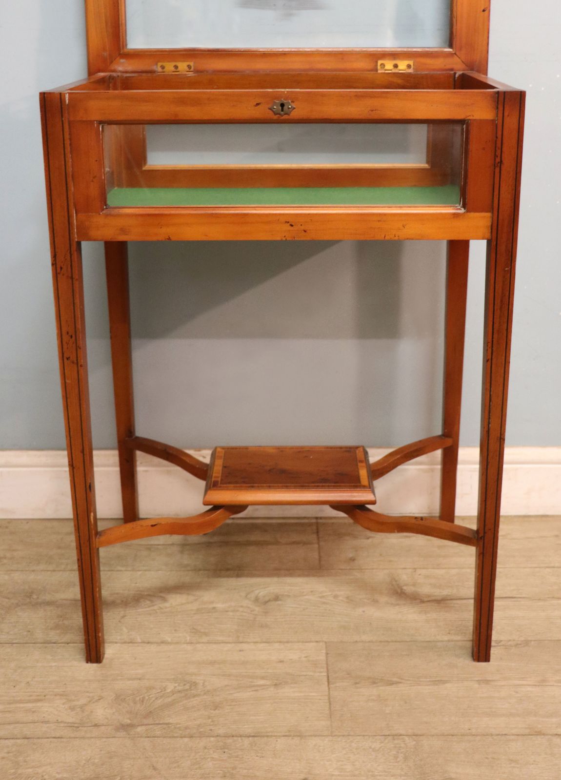 photo vintage A Lovely Yew Wood Veneered Bijouterie Display Table, Later Sign Written For Breitling Watches.