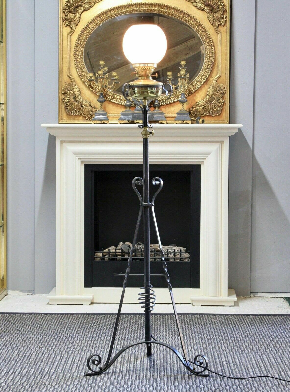 An Arts & Crafts Style Wrought Iron Brass Rise And Fall Standard Lamp