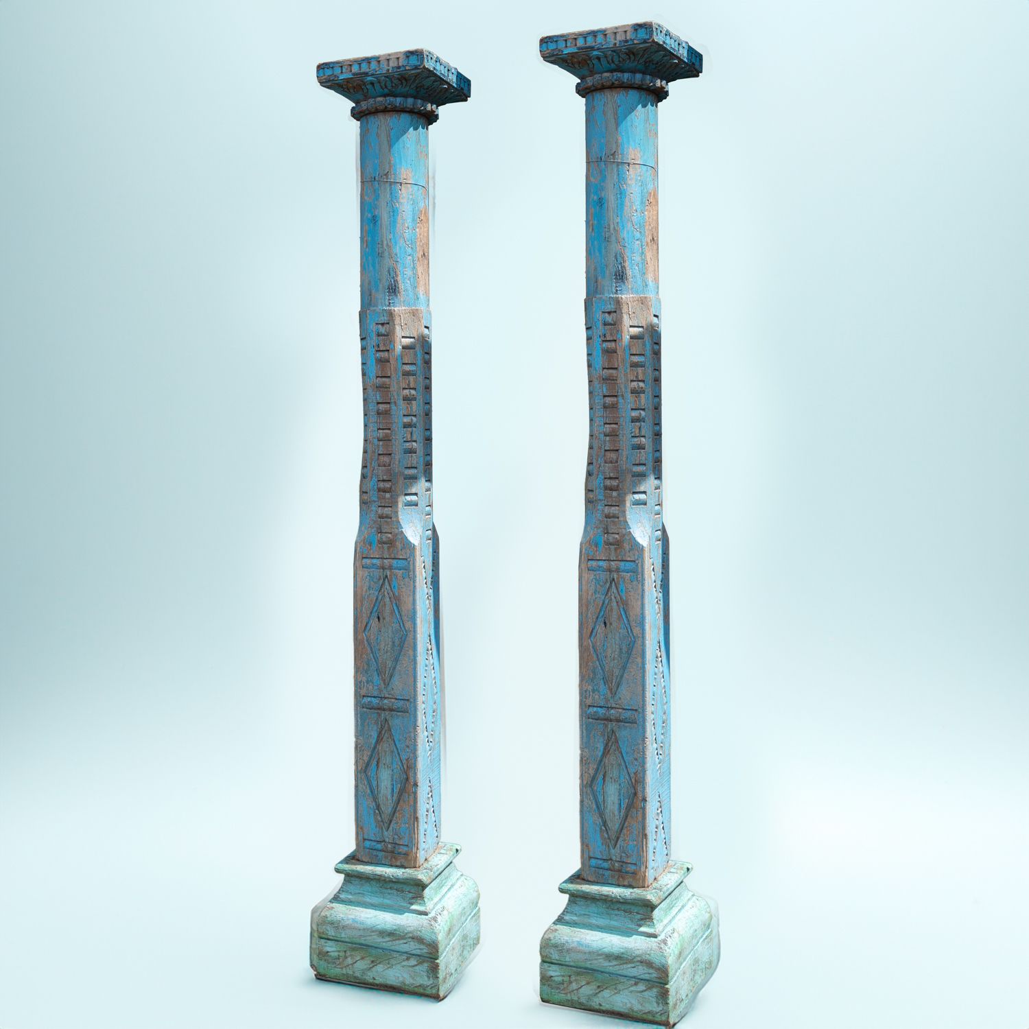 Pair Of Reclaimed Blue Carved Indian Columns On Wooden Plinths
