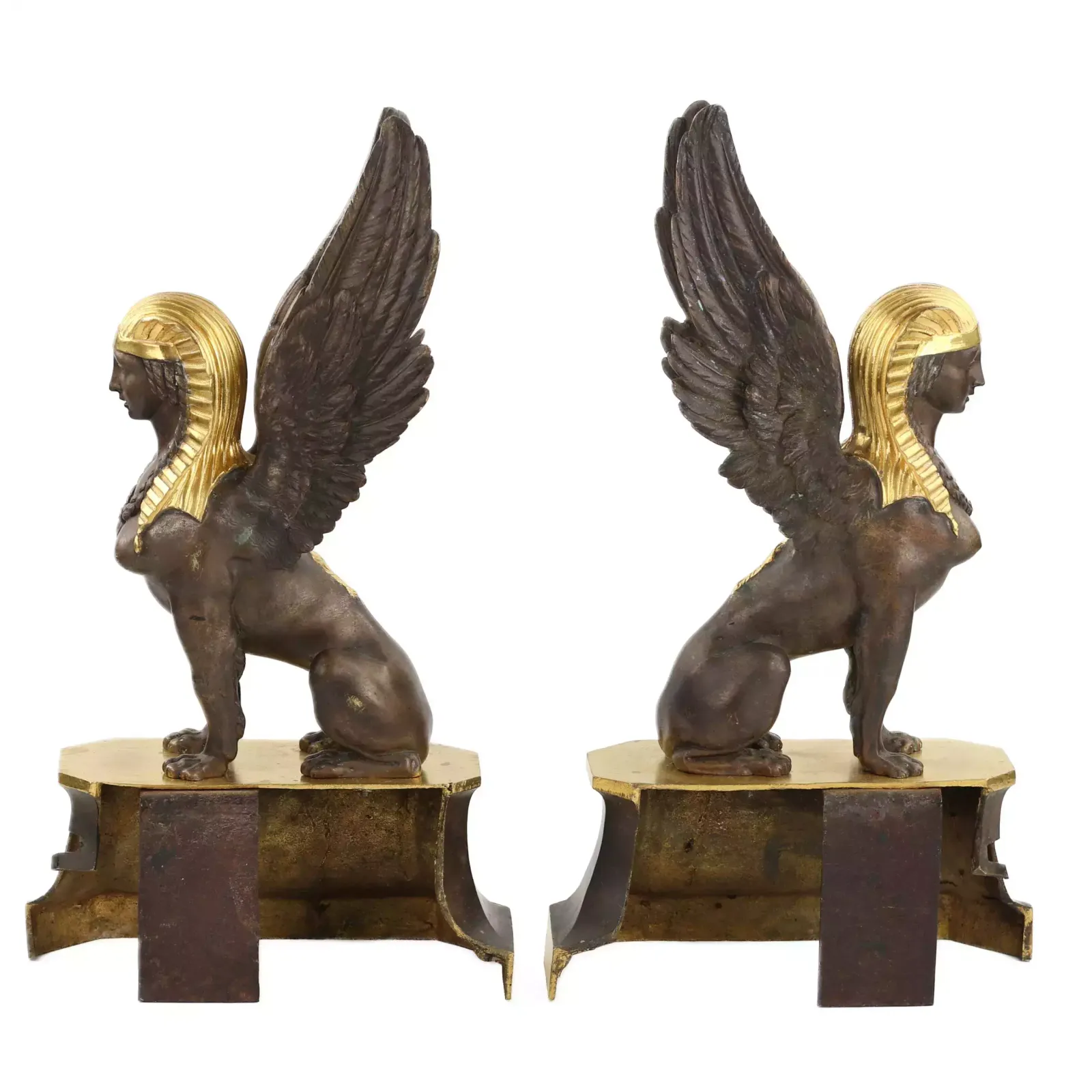 A Pair Of Patinated And Gilded Bronze Firewood Stands In The Shape Of Winged Sphinxes. 19th Century. photo Home Fixtures