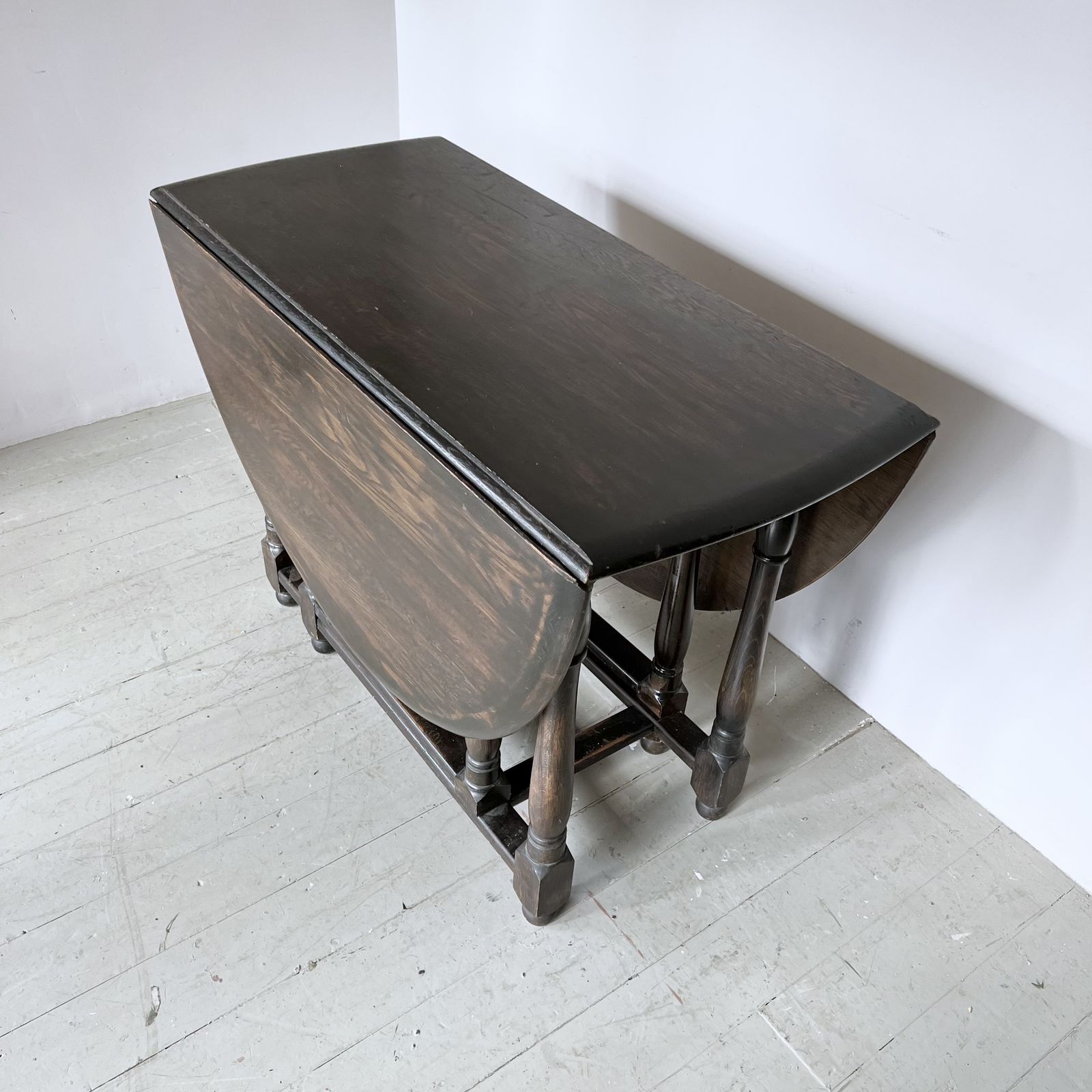 photo furniture Dark Stained Solid Wood Oval Drop Leaf Table