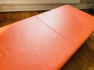 photo furniture Mid Century Danish Style Long Bench. Orange Vinyl Upholstery And Stainless Steel Legs. Orangebox.