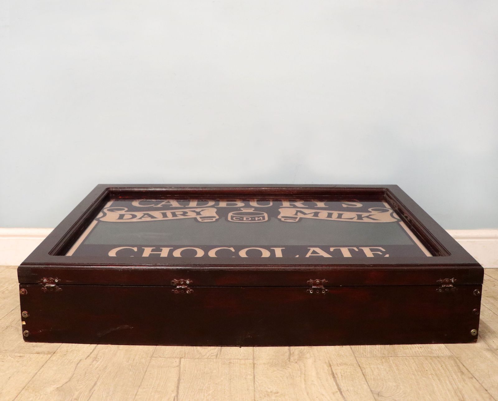 A Superb Wedge Shaped Countertop Display Cabinet, Later Hand Sign Written For Cadburys Dairy Milk Chocolate. photo furniture