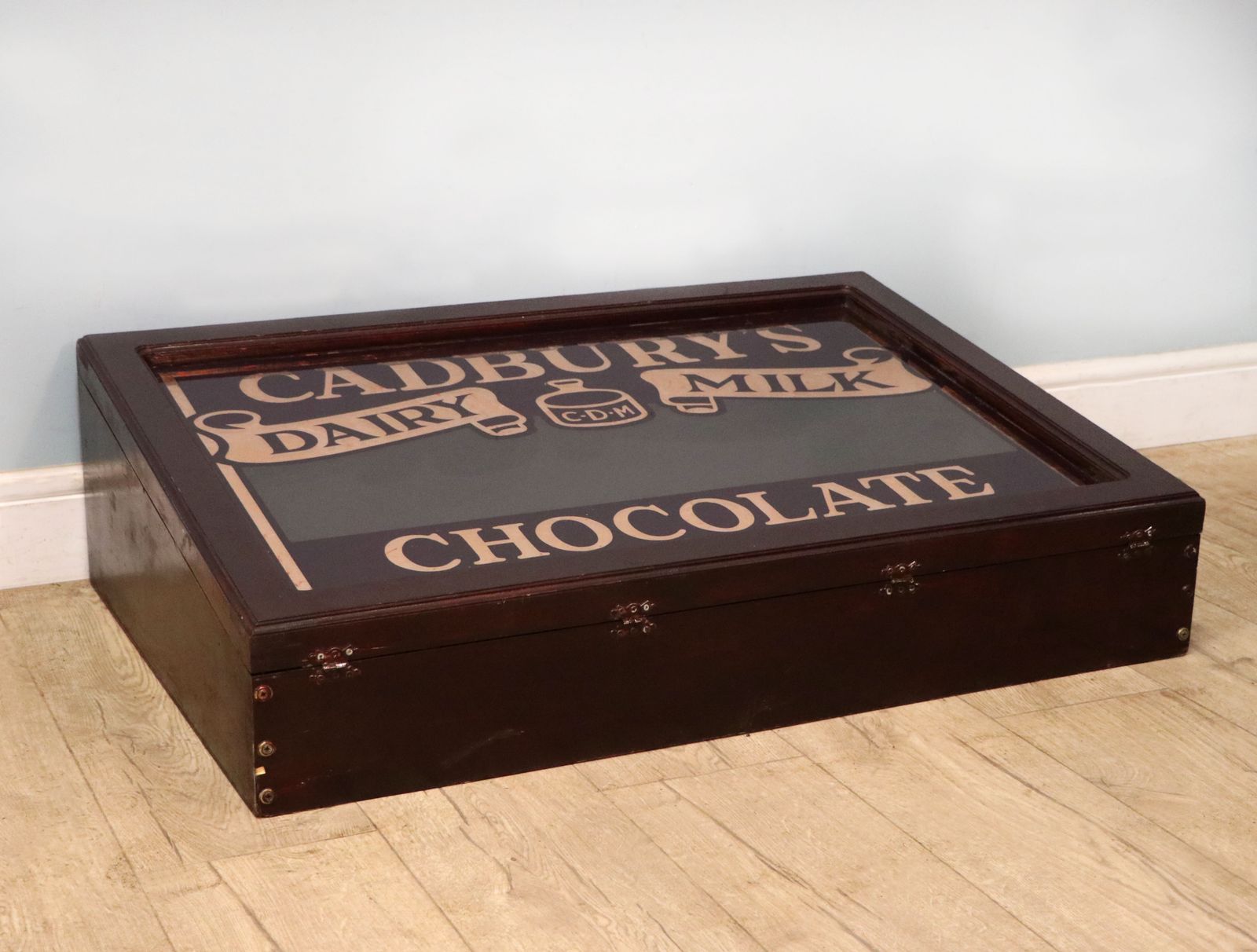 A Superb Wedge Shaped Countertop Display Cabinet, Later Hand Sign Written For Cadburys Dairy Milk Chocolate. photo vintage
