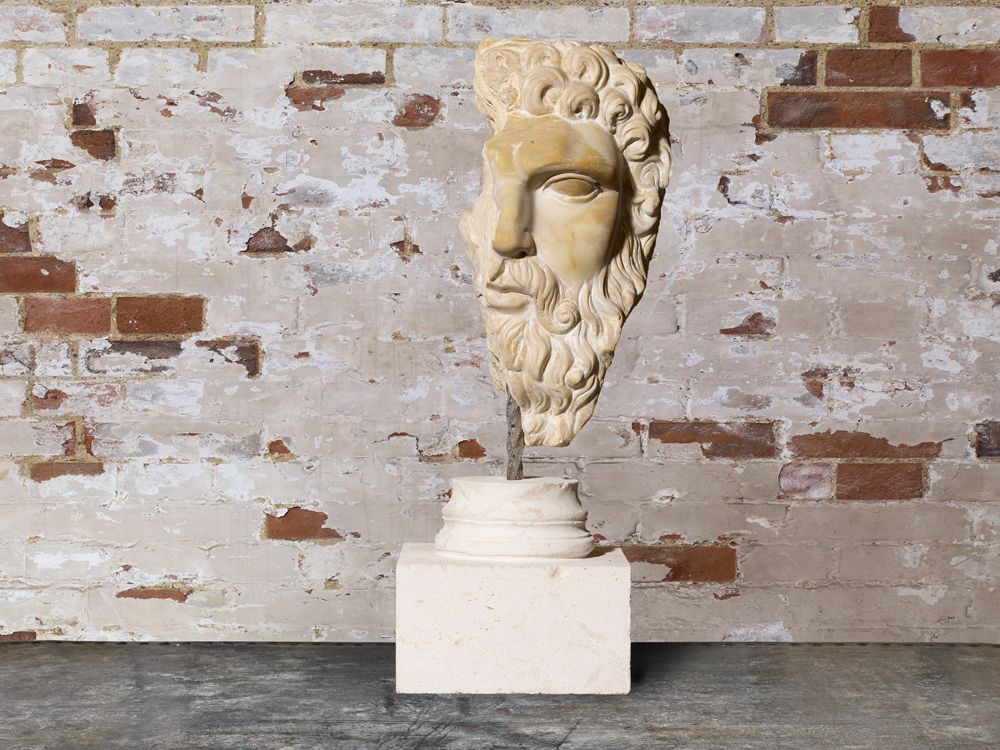 Carved Stone Head Of Hercules. photo furniture