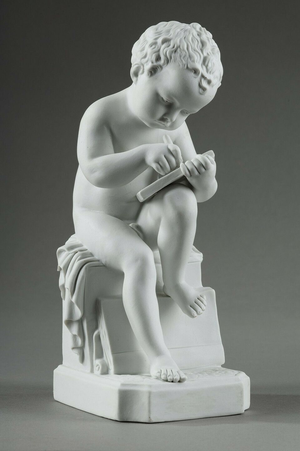 Two Subjects At Biscuit Representing The Child Reading And The Child Drawing. photo furniture