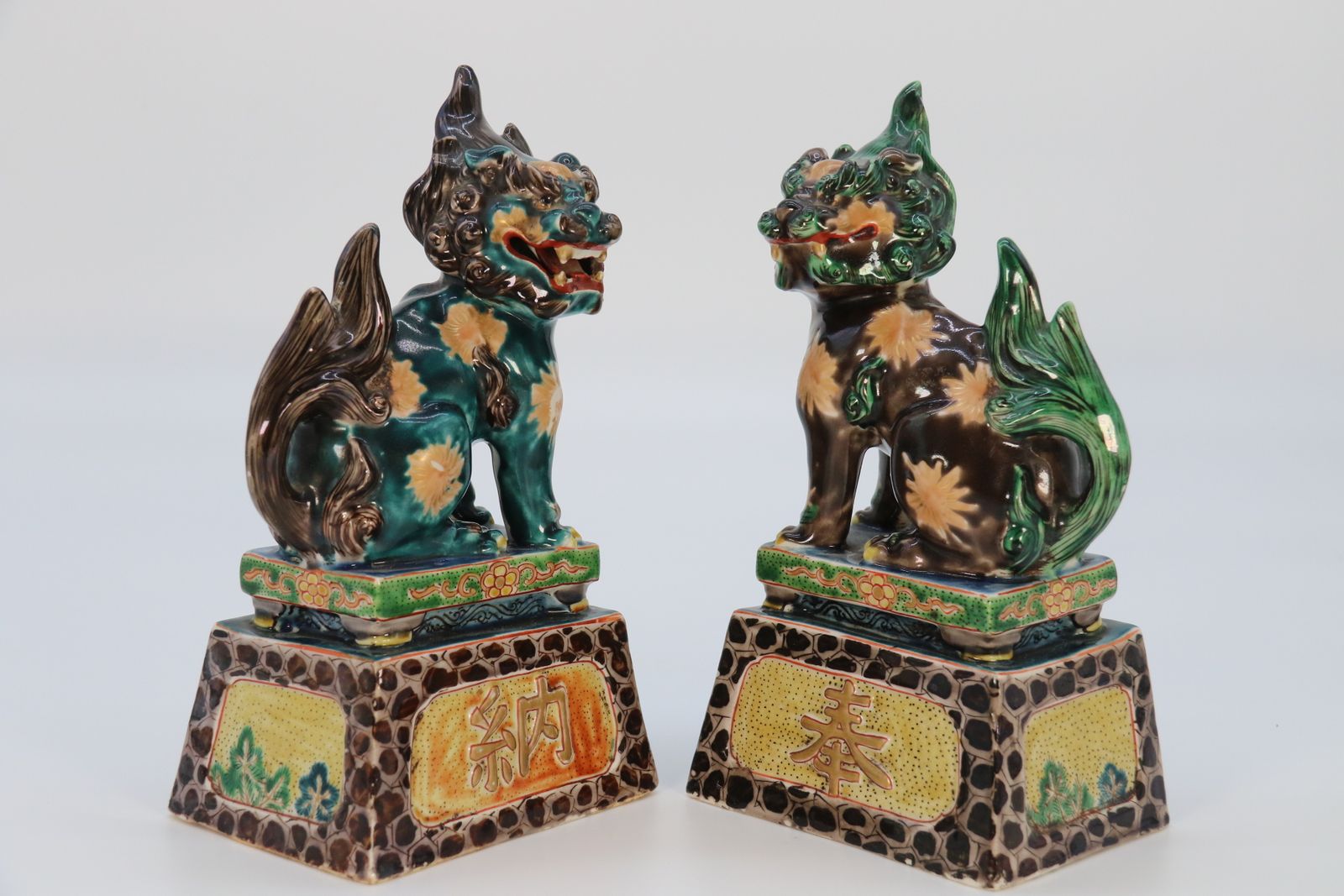 photo furniture A Highly Decorative Pair Of Chinese Pottery Buddhist Lions Circa 1900.