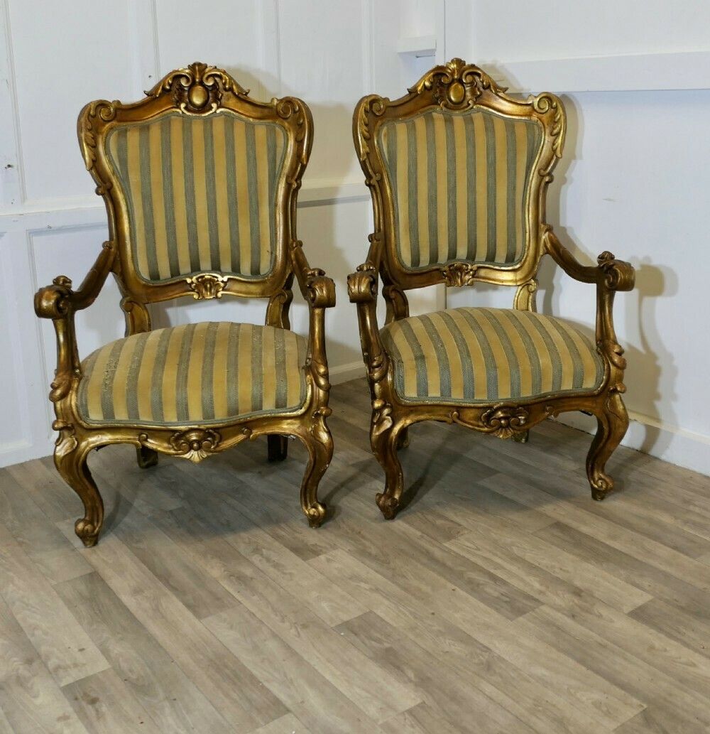 A Pair Of Large Italian Carved Giltwood Arm Chairs