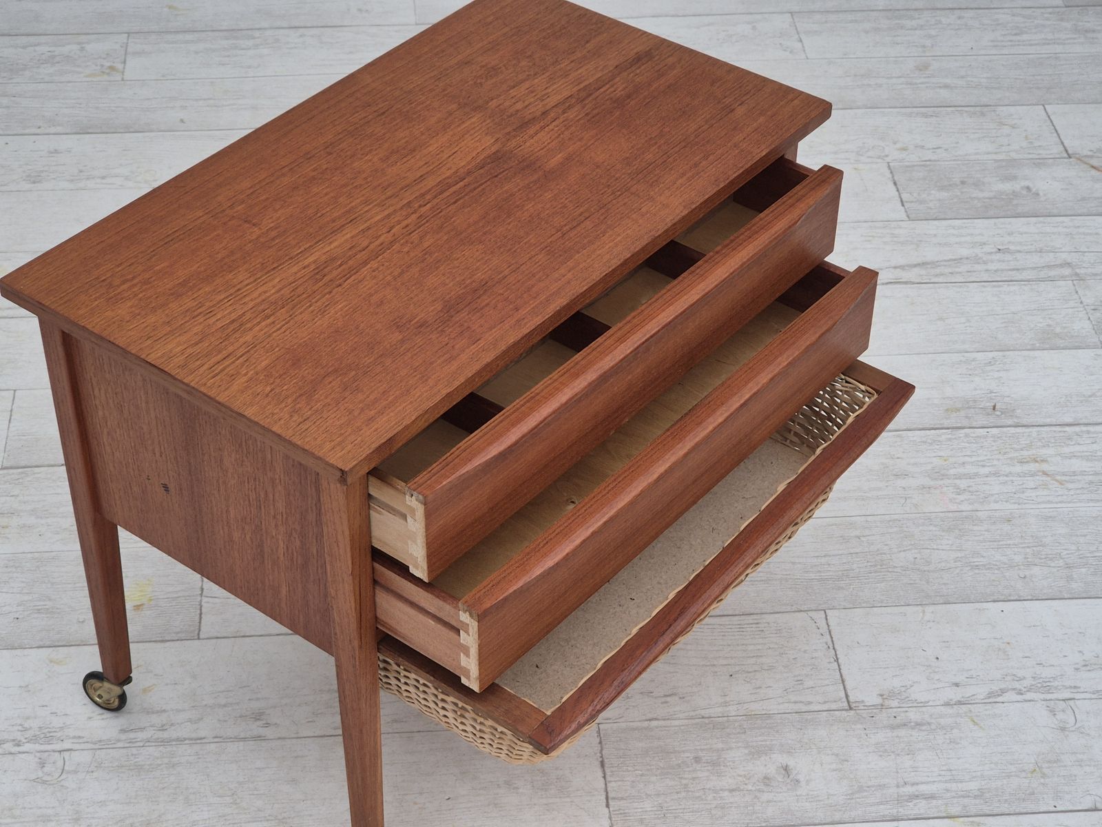 photo for sale 1970s, Danish Side Chest Of Drawers, Teak Wood, Rattan, Brass Wheels, Original Condition.