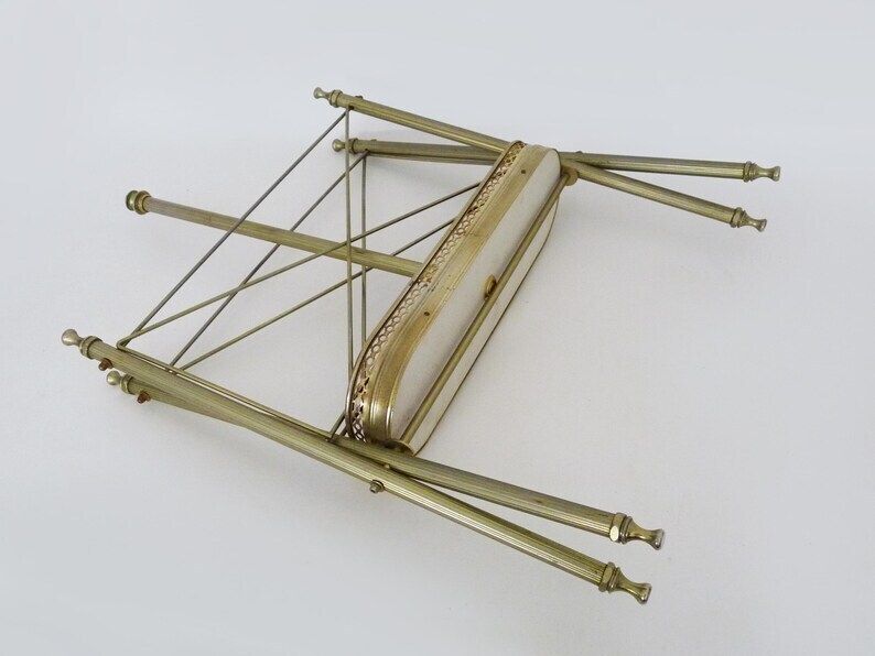 photo furniture Neoclassical Baroque Folding Magazine Rack In Gold Metal. 50s