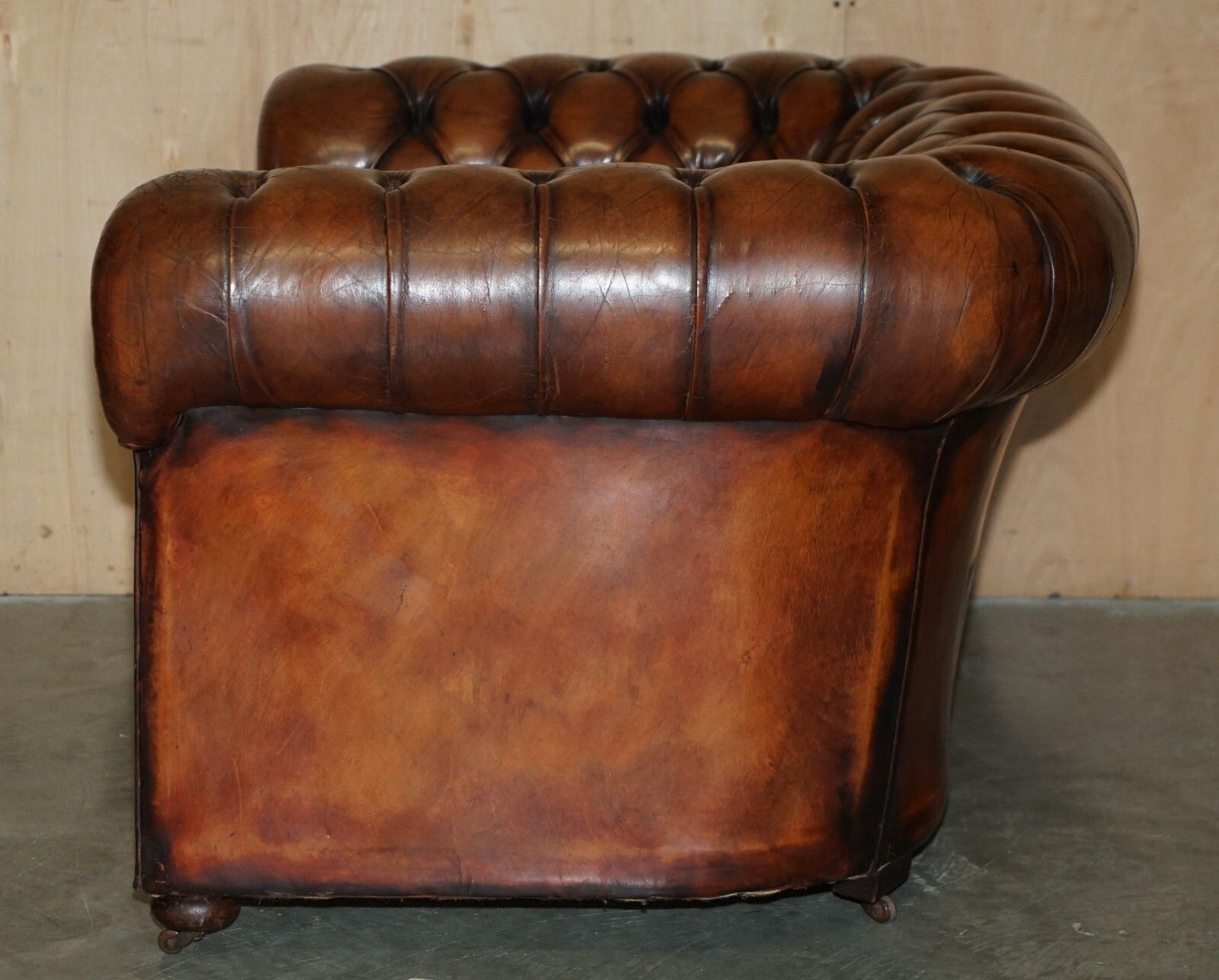 photo vintage Restored Antique Chesterfield Club Armchair Brown Leather Porcelain Castors