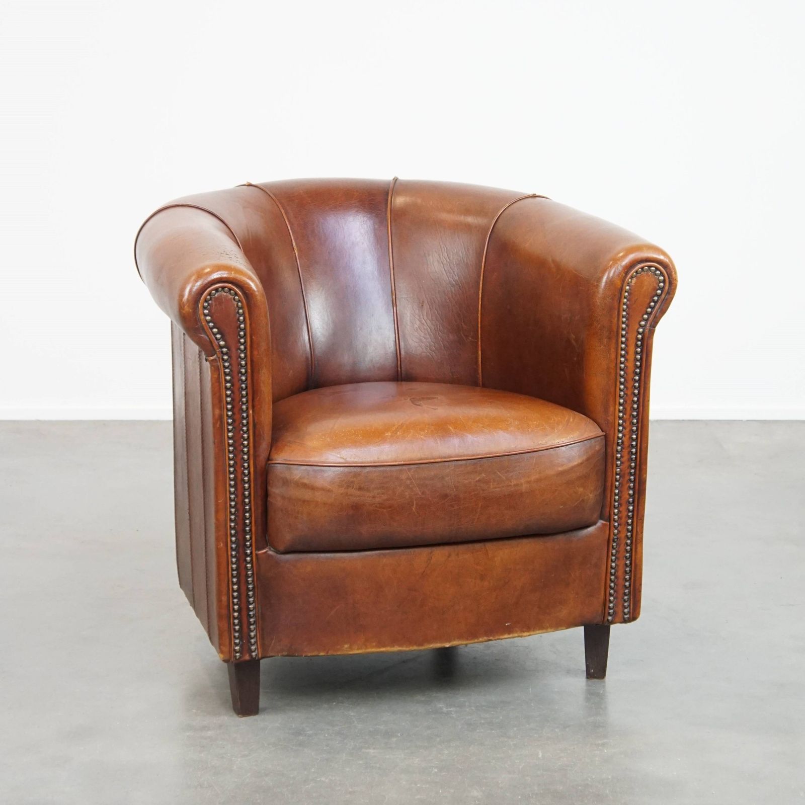 Sheepskin Club Chair In A Charming Cognac Colour And Finished With Piping On The Backrest