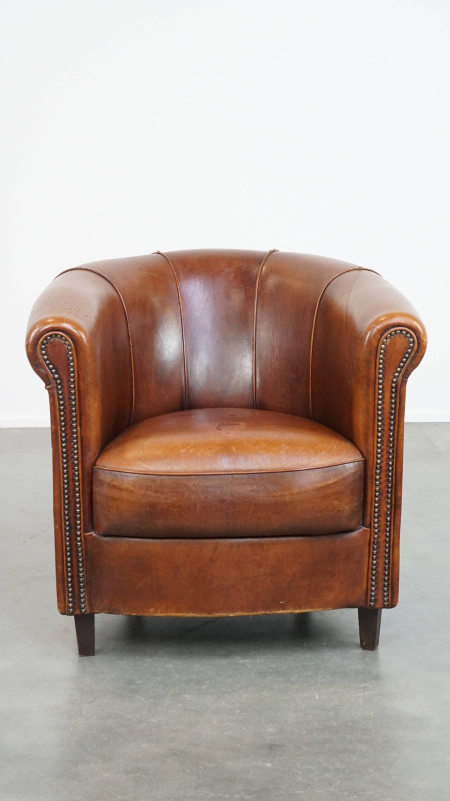Sheepskin Club Chair In A Charming Cognac Colour And Finished With Piping On The Backrest photo furniture