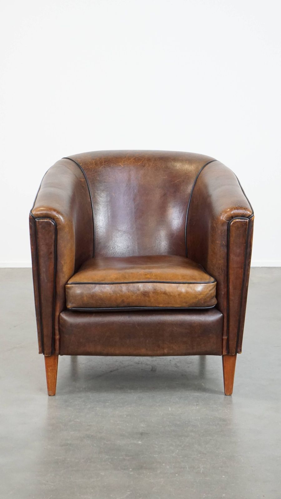 Donkere En Strakke Clubfauteuil Van Schapenvacht Met Mooie Kleuren En Zwarte Paspelafwerking photo furniture