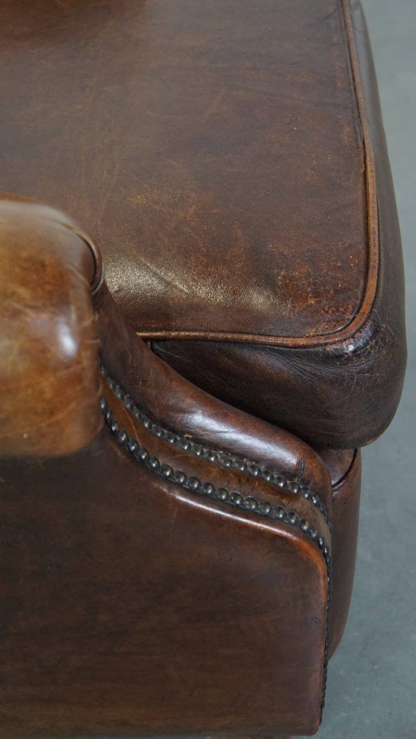 Furniture Classic, Dark, Good Condition Sheepskin Armchair With Beautiful Round Shapes And On Wheels photo
