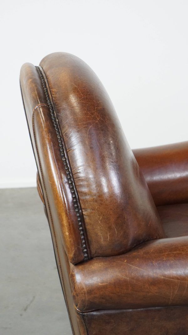 1016.1353999999999 Klassieke Schapenvacht Fauteuil In Donkere Kleur, Goede Staat, Met Ronde Vormen En Op Wieltjes photo