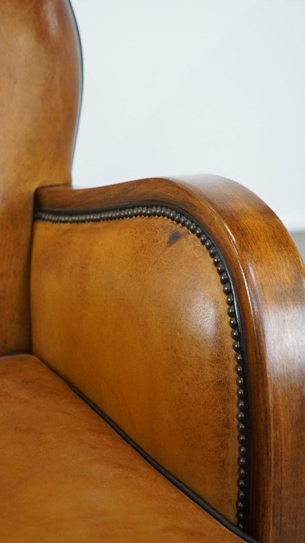 Furniture Unique, Luxurious Sheepskin Armchair Combined With Wood And Finished With Decorative Nails photo
