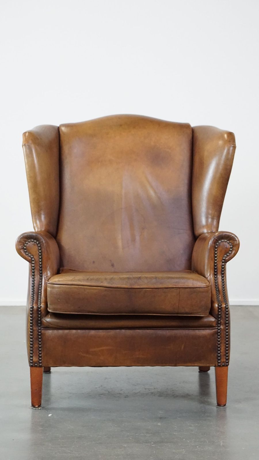 Charming Sheepskin Wing Chair With A Beautiful Patina And Good Seating Comfort photo furniture