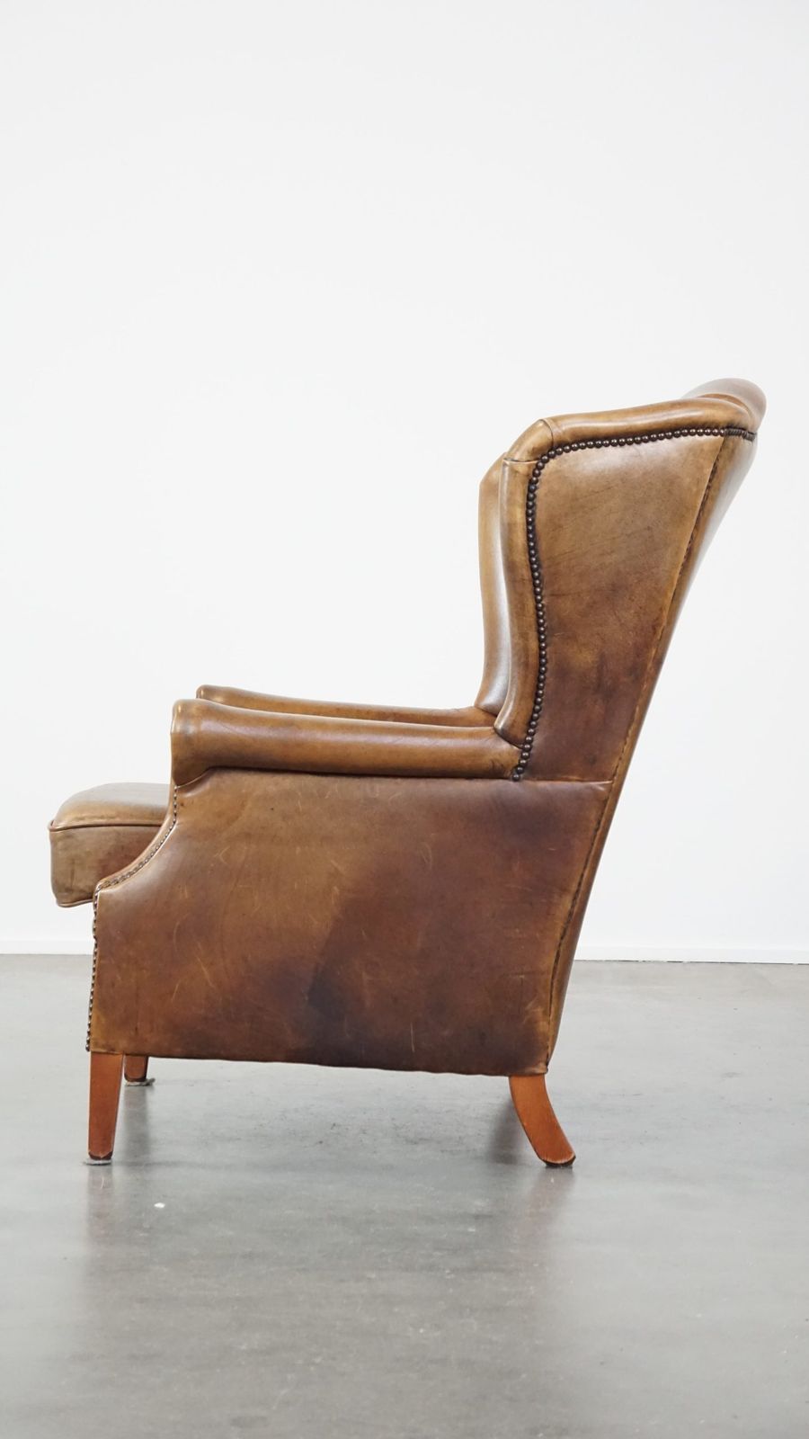 Charming Sheepskin Wing Chair With A Beautiful Patina And Good Seating Comfort photo 778.8927
