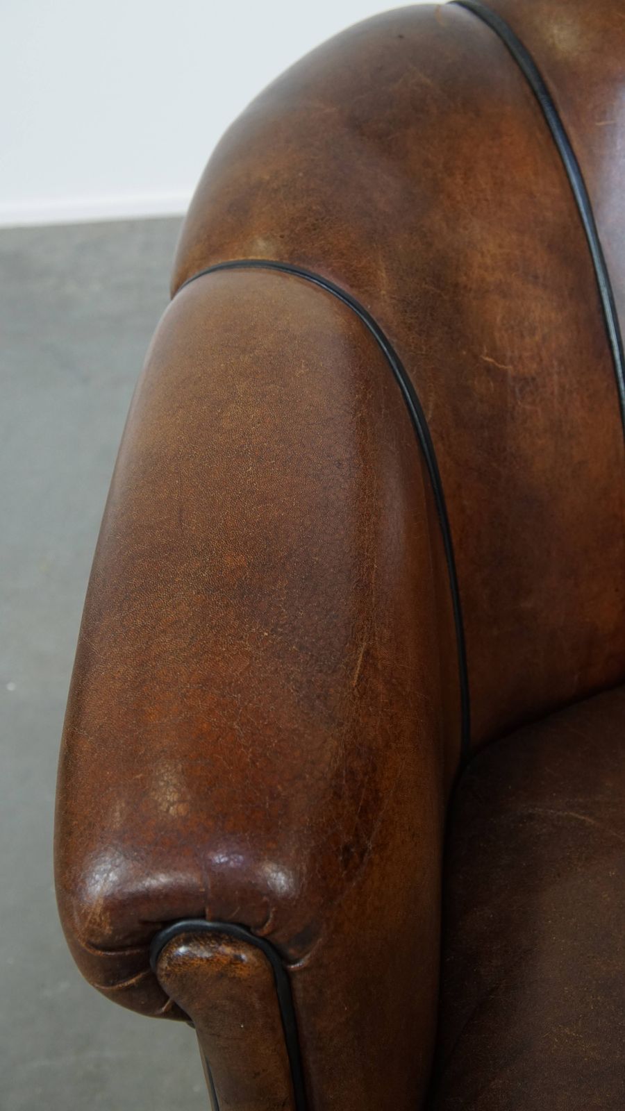 Special, Characteristic And Stately Dark Sheepskin Club Chair With A Black Piping Finish photo buy