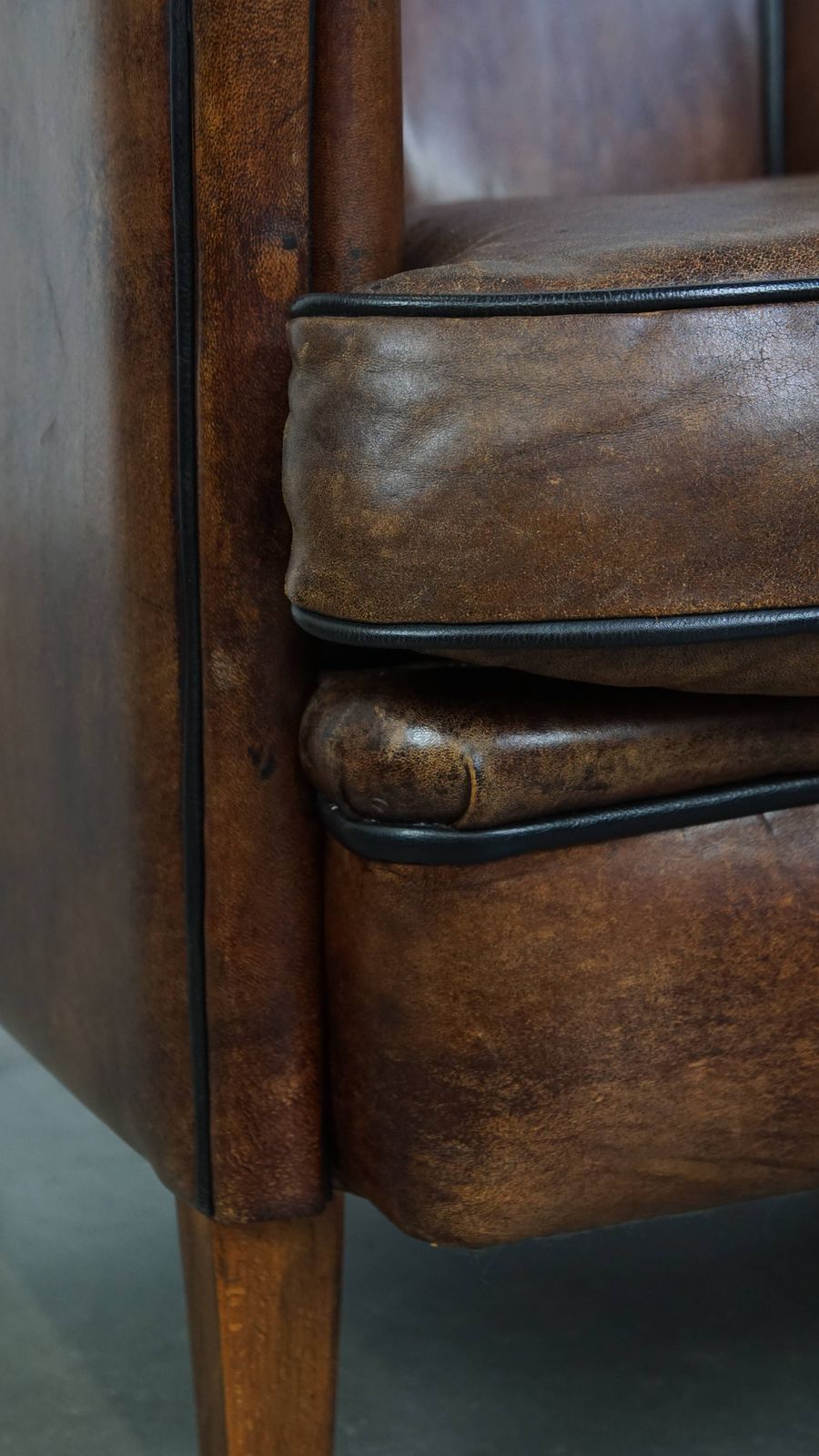 Furniture Special, Characteristic And Stately Dark Sheepskin Club Chair With A Black Piping Finish photo