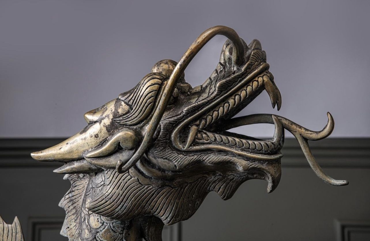 A Large Brass Dragon Chasing The Flaming Pearl Of Knowledge photo for sale