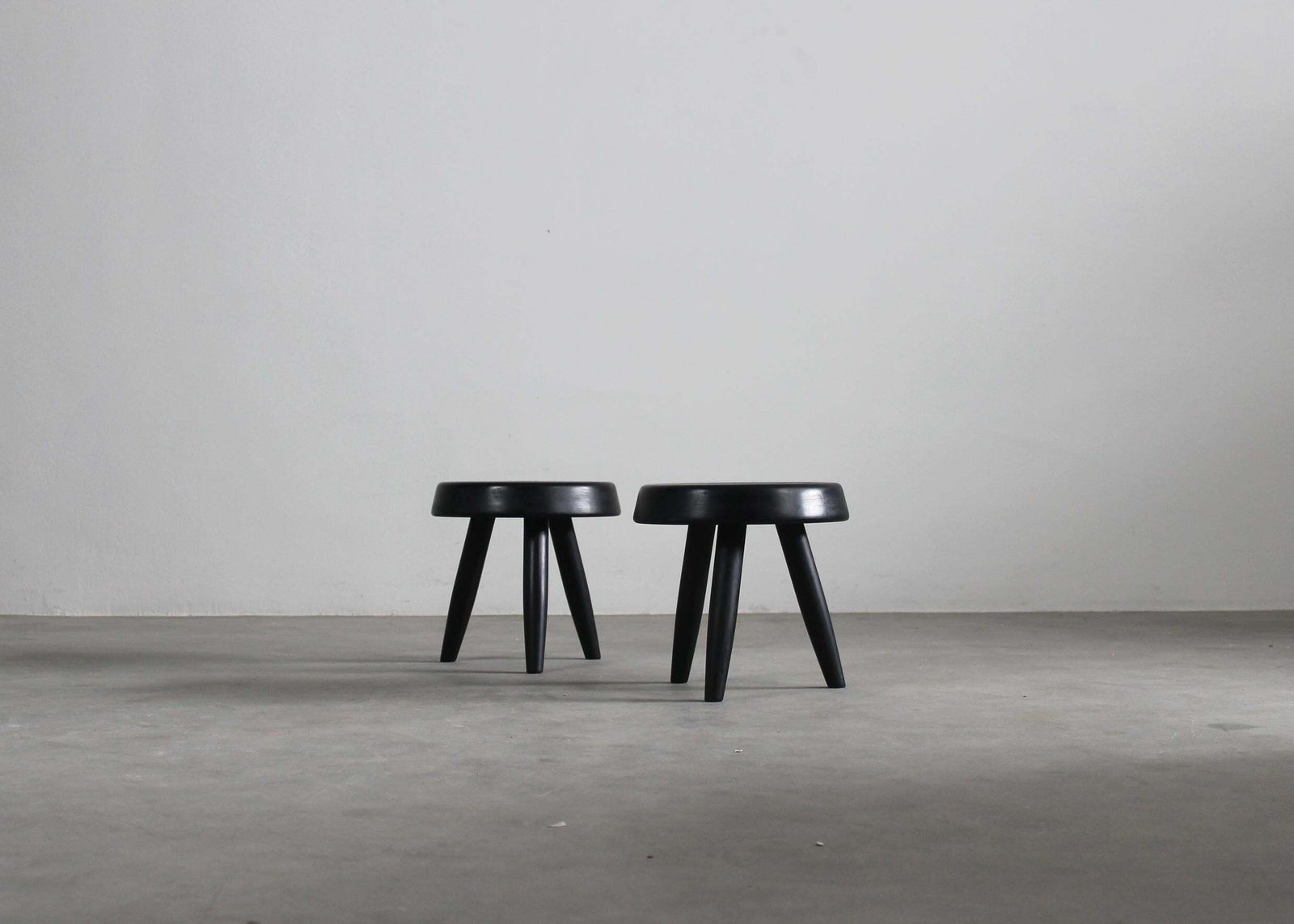 Charlotte Perriand Set Of Two Black Stools In Wood 1950s photo for sale