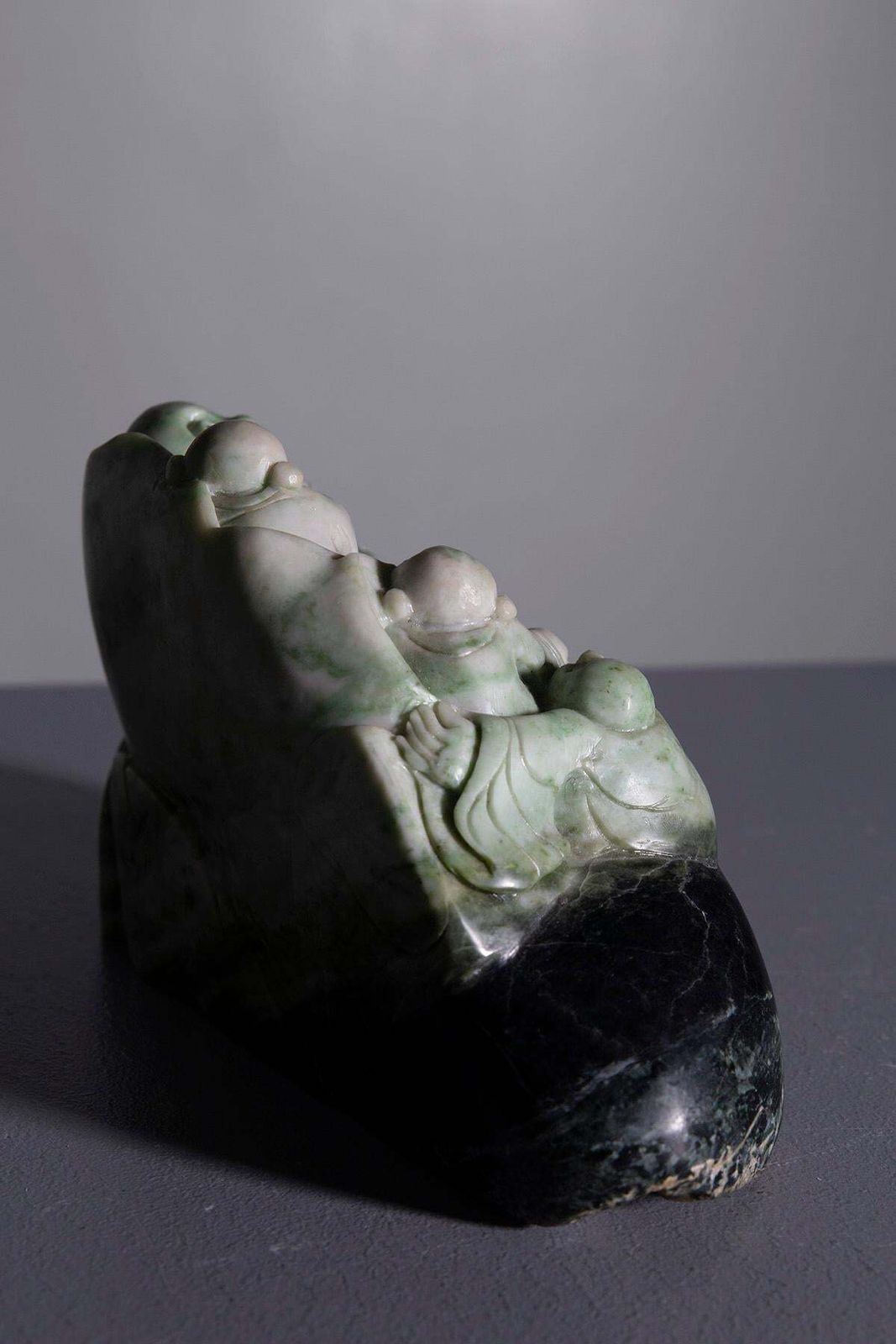 Sculpture Of Buddha Surrounded By Children In Jade Root photo furniture
